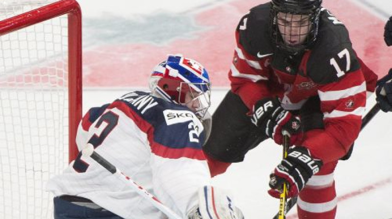 Slovākijas vārtsargs Davids Okolicanijs pret Kanādas uzbrucēju Konoru Makdeividu
Foto: AP/Scanpix
